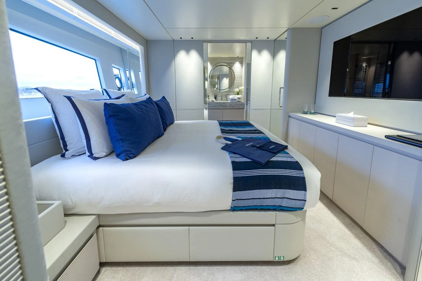 The stateroom features a luxurious bed with elegant linens and a modern, minimalist design. aboard AMER 120/11 Yacht for Sale