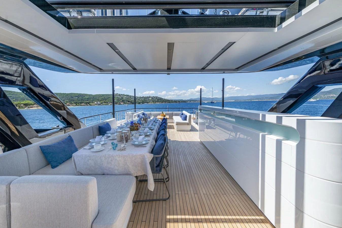 The aft deck features an elegant dining area with panoramic ocean views. aboard AMER 120/11 Yacht for Sale