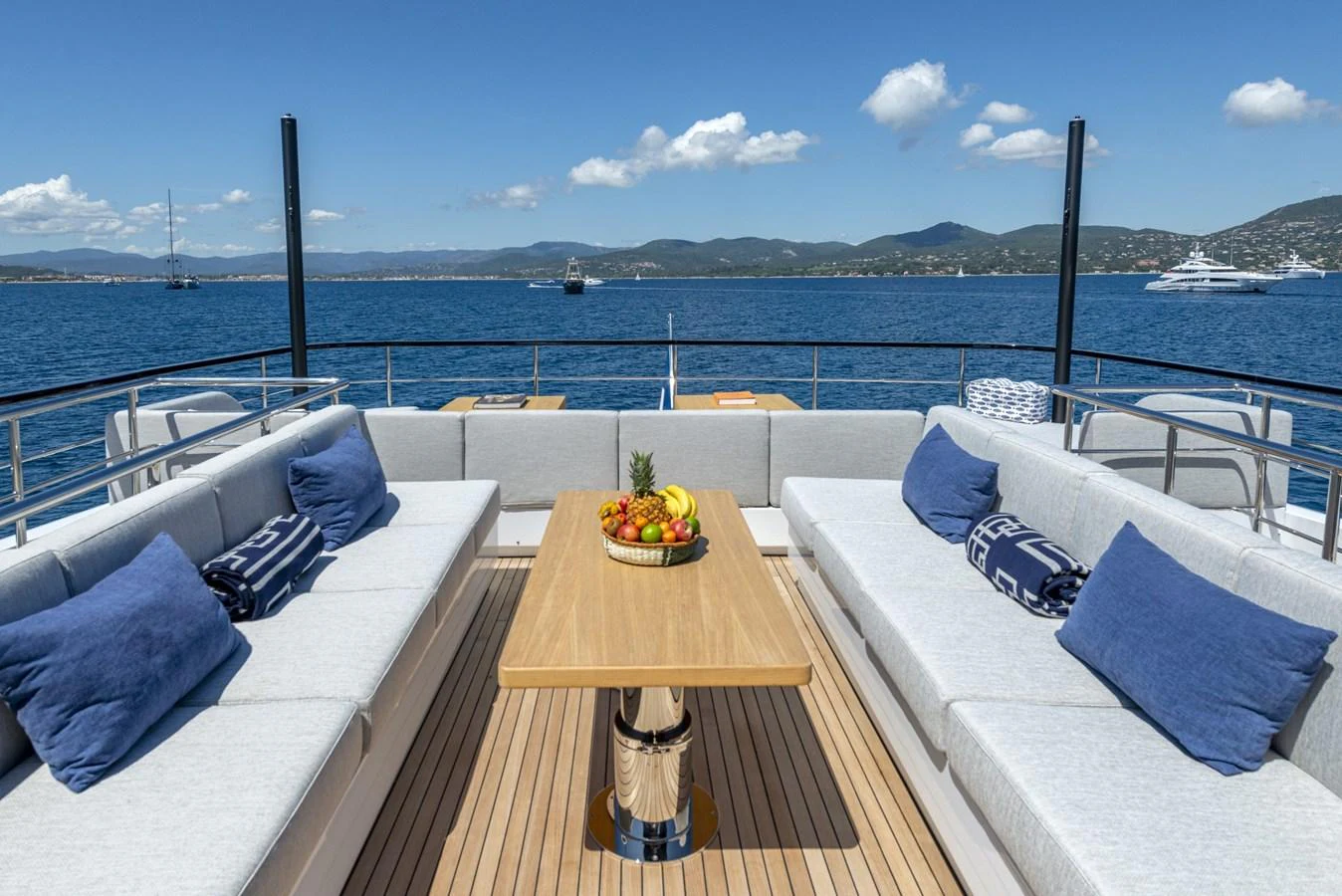 The aft deck offers a luxurious outdoor seating area with plush cushions and a central table, perfect for alfresco dining and relaxation. aboard AMER 120/11 Yacht for Sale