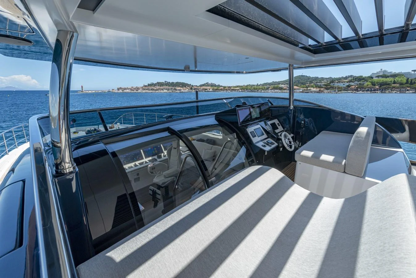 The helm station offers a panoramic view with modern navigation equipment and comfortable seating. aboard AMER 120/11 Yacht for Sale