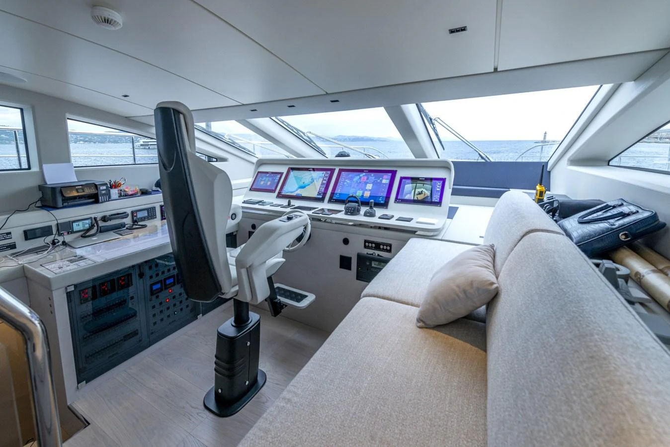 The helm station features advanced navigation equipment and a comfortable seating area with panoramic views. aboard AMER 120/11 Yacht for Sale