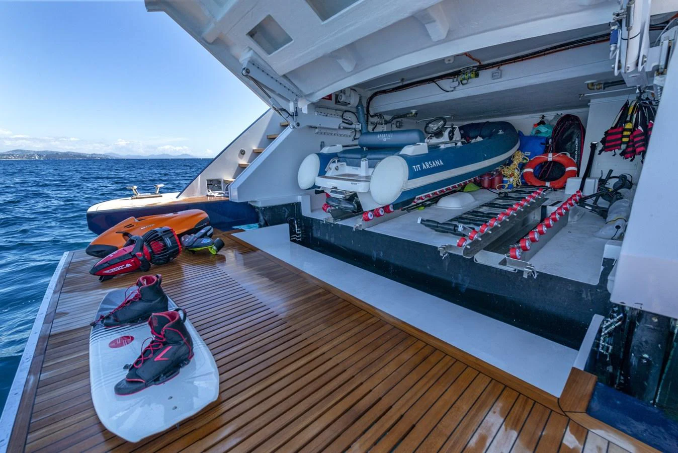 The yacht's toy garage is well-equipped with water sports gear and a tender, ready for adventure. aboard AMER 120/11 Yacht for Sale