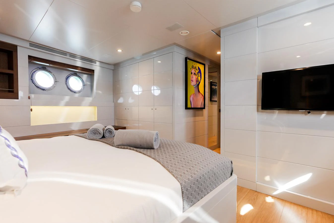 The stateroom features a comfortable bed, modern decor, and ample natural light. aboard ONLY NOW Yacht for Sale