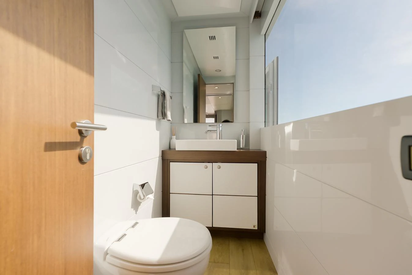 A modern yacht bathroom with sleek fixtures and a large window providing ample natural light. aboard ONLY NOW Yacht for Sale