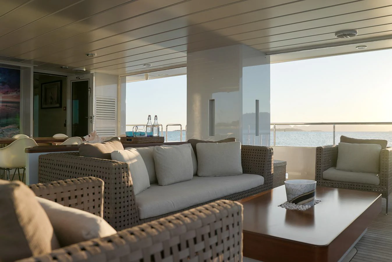 The salon features comfortable seating with a view of the sea through large windows. aboard ONLY NOW Yacht for Sale