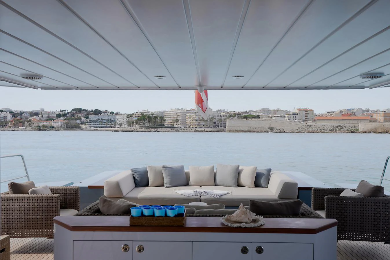 The aft deck features a comfortable seating area with a scenic view of the coastline. aboard ONLY NOW Yacht for Sale