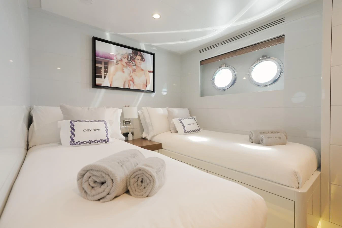 The guest stateroom offers a serene and comfortable space with twin beds and modern decor. aboard ONLY NOW Yacht for Sale