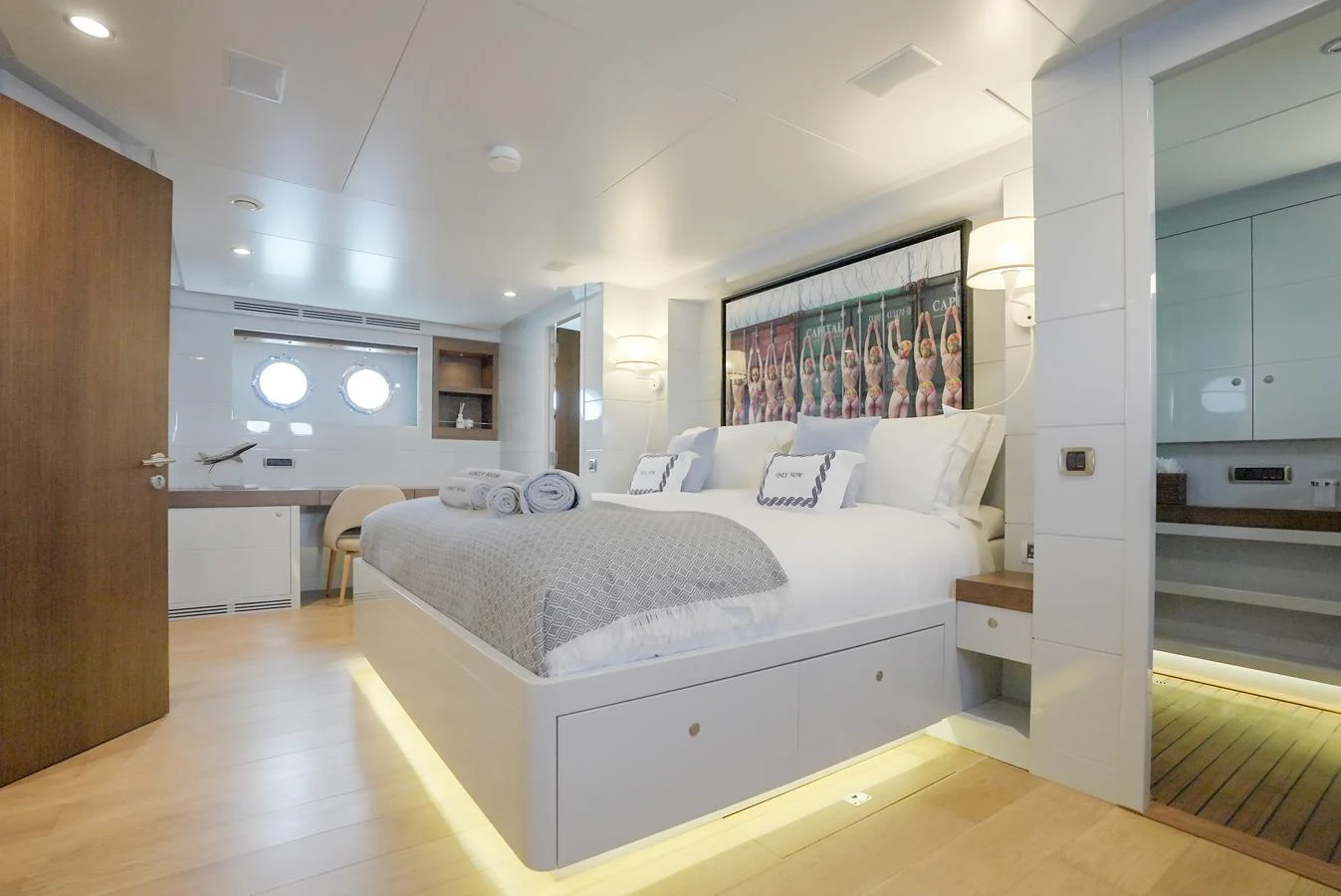 The stateroom features a luxurious bed with elegant decor and ample natural light. aboard ONLY NOW Yacht for Sale