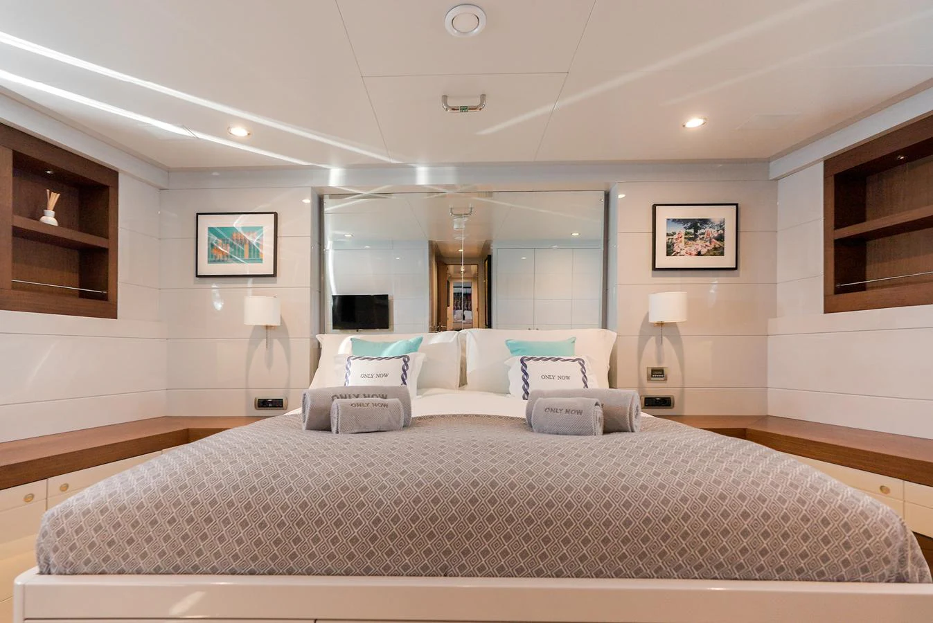 The stateroom features a plush bed with elegant decor and ample natural light. aboard ONLY NOW Yacht for Sale