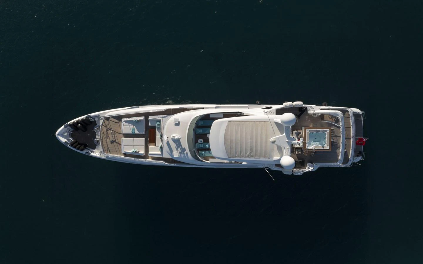 An aerial view of a sleek yacht showcasing its elegant design and spacious deck areas. aboard NECHIDA Yacht for Sale