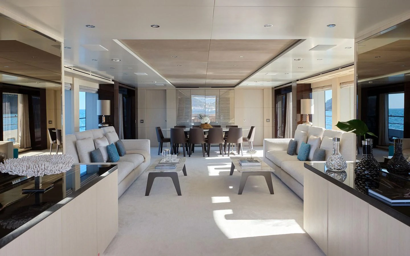 The spacious salon features elegant seating and a sophisticated dining area with panoramic views. aboard NECHIDA Yacht for Sale