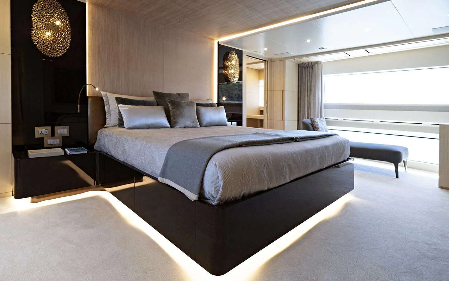 The master stateroom features a luxurious bed with elegant lighting and modern decor. aboard NECHIDA Yacht for Sale