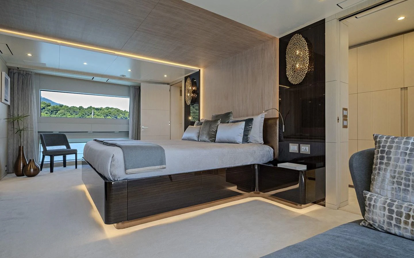The master stateroom features a luxurious bed with modern decor and ample natural light. aboard NECHIDA Yacht for Sale
