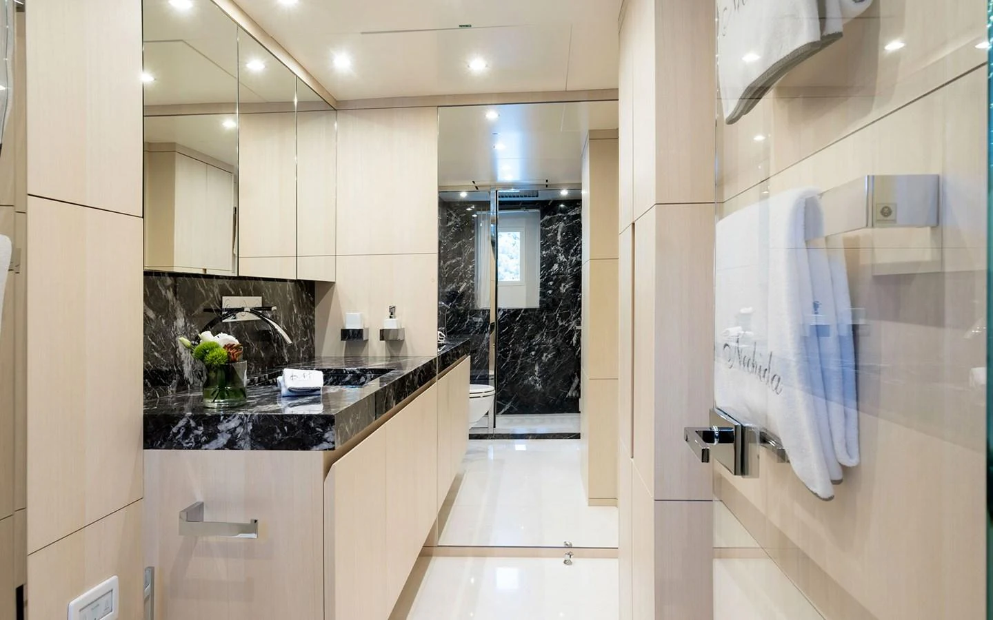 The yacht's bathroom features elegant black marble accents and modern fixtures. aboard NECHIDA Yacht for Sale