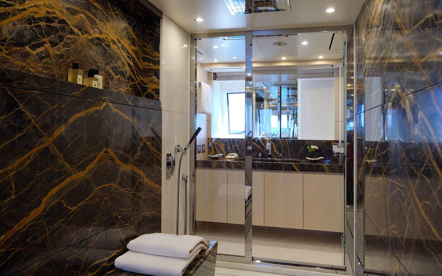 The luxurious bathroom features elegant marble walls and modern fixtures. aboard NECHIDA Yacht for Sale