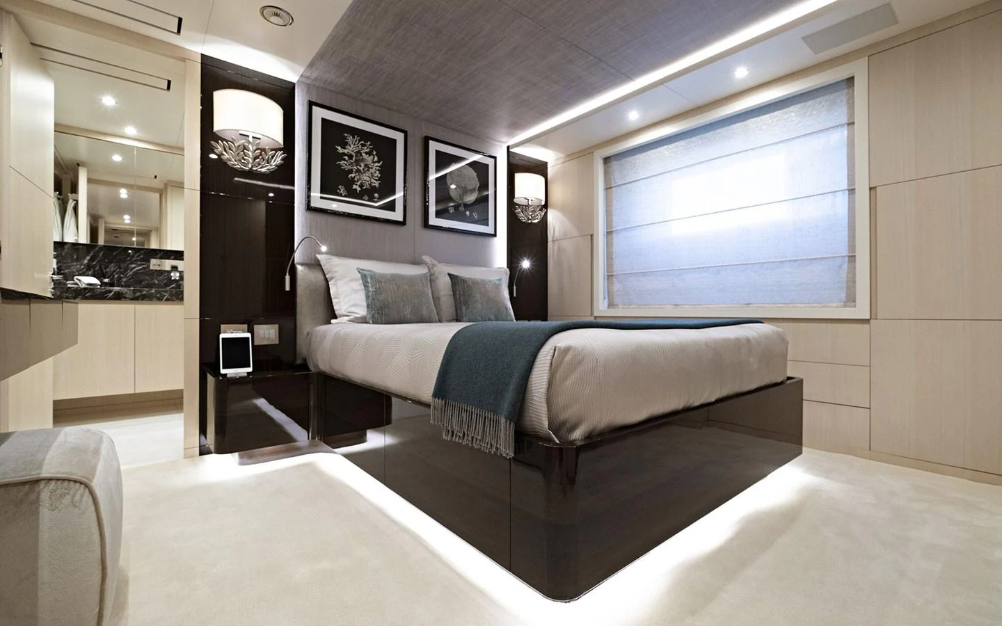 The stateroom features a luxurious bed with modern decor and ample natural light. aboard NECHIDA Yacht for Sale