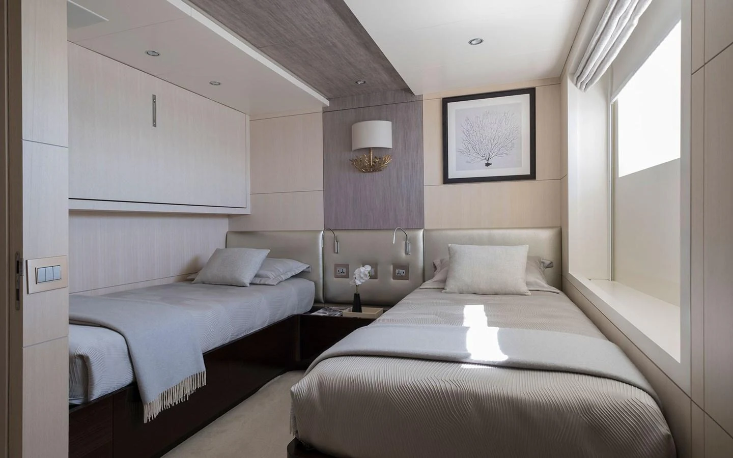 The guest stateroom features two single beds with elegant, modern decor and ample natural light. aboard NECHIDA Yacht for Sale