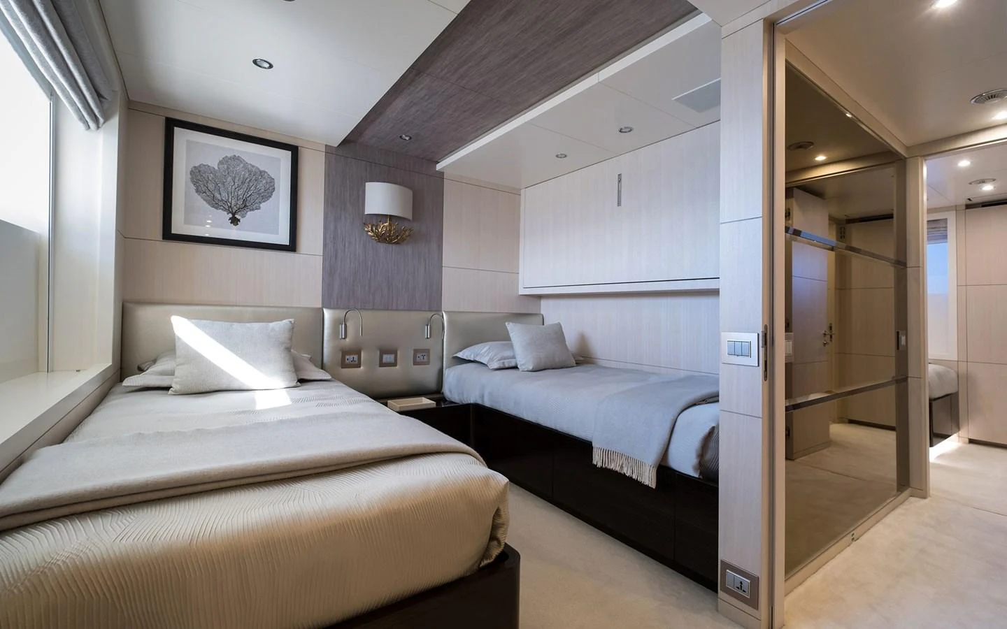 The guest stateroom features twin beds with elegant decor and ample natural light. aboard NECHIDA Yacht for Sale