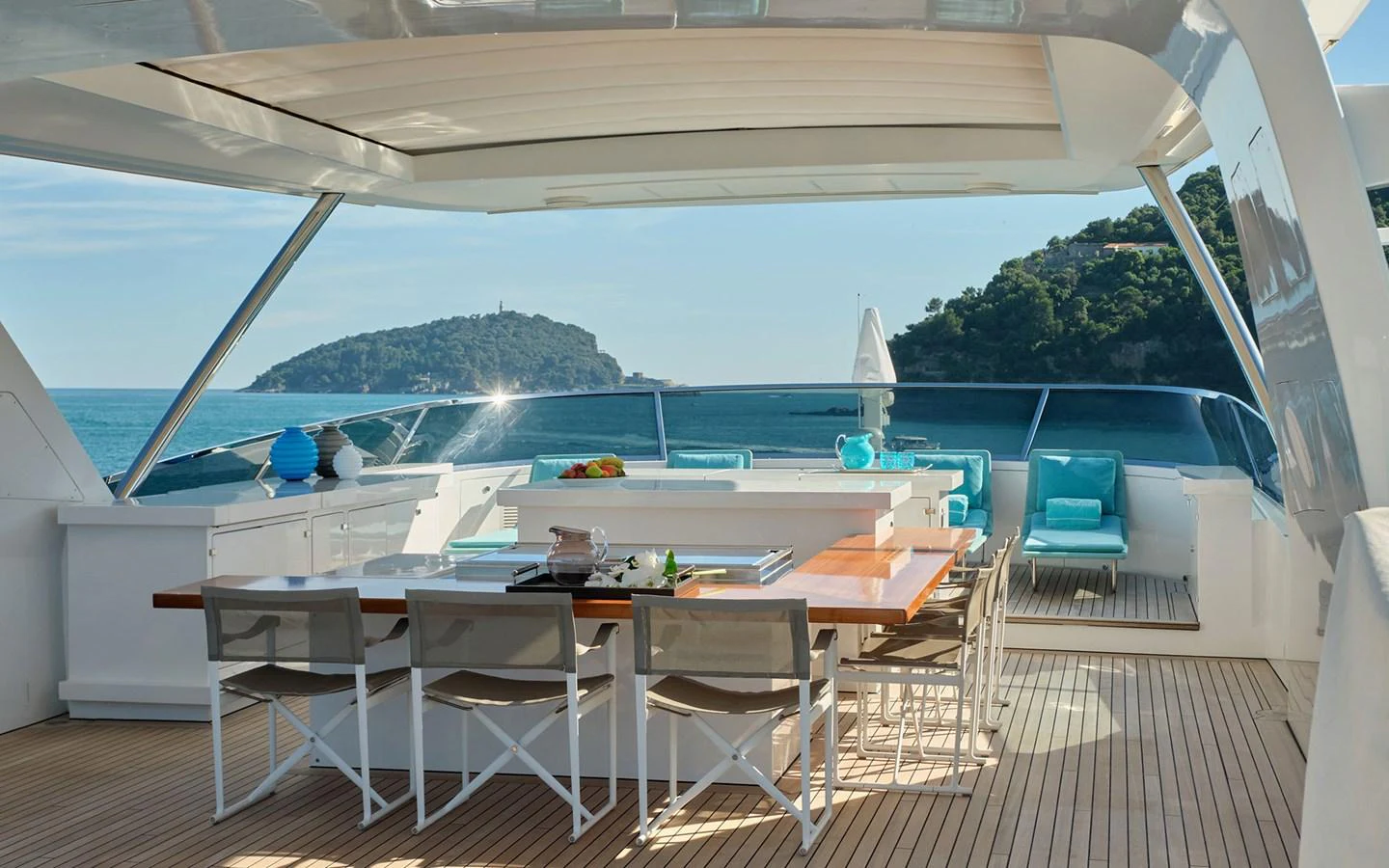 The aft deck offers an inviting dining area with stunning ocean views and comfortable seating. aboard NECHIDA Yacht for Sale