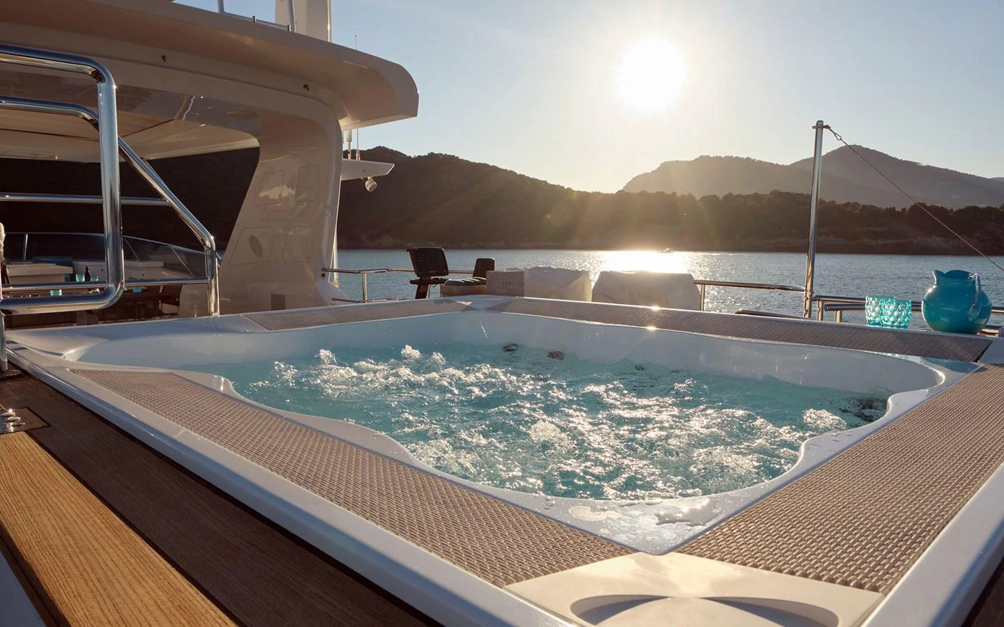 A luxurious jacuzzi on the deck offers a relaxing experience with stunning sunset views over the water. aboard NECHIDA Yacht for Sale