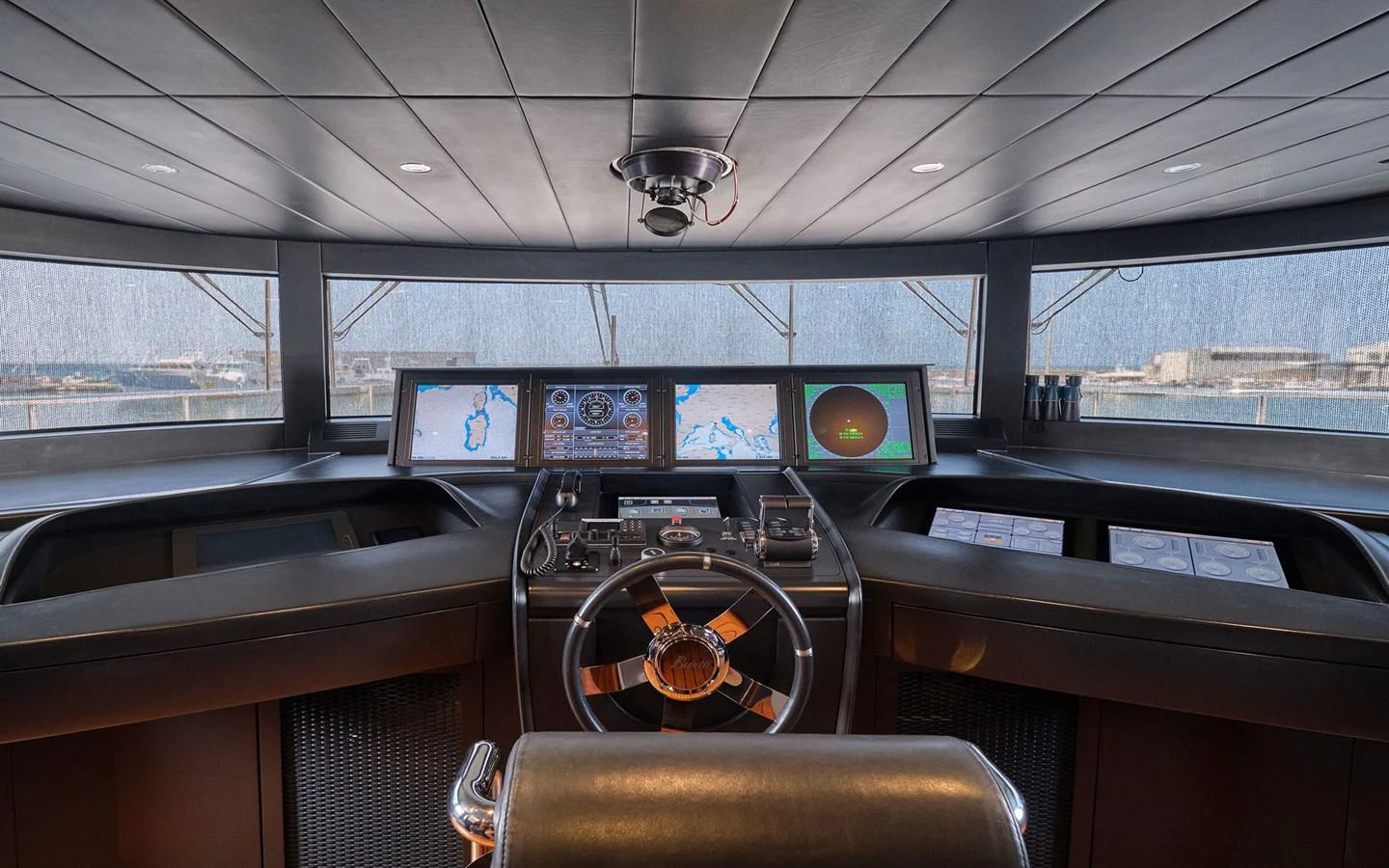 The helm station features advanced navigation equipment and a panoramic view. aboard NECHIDA Yacht for Sale