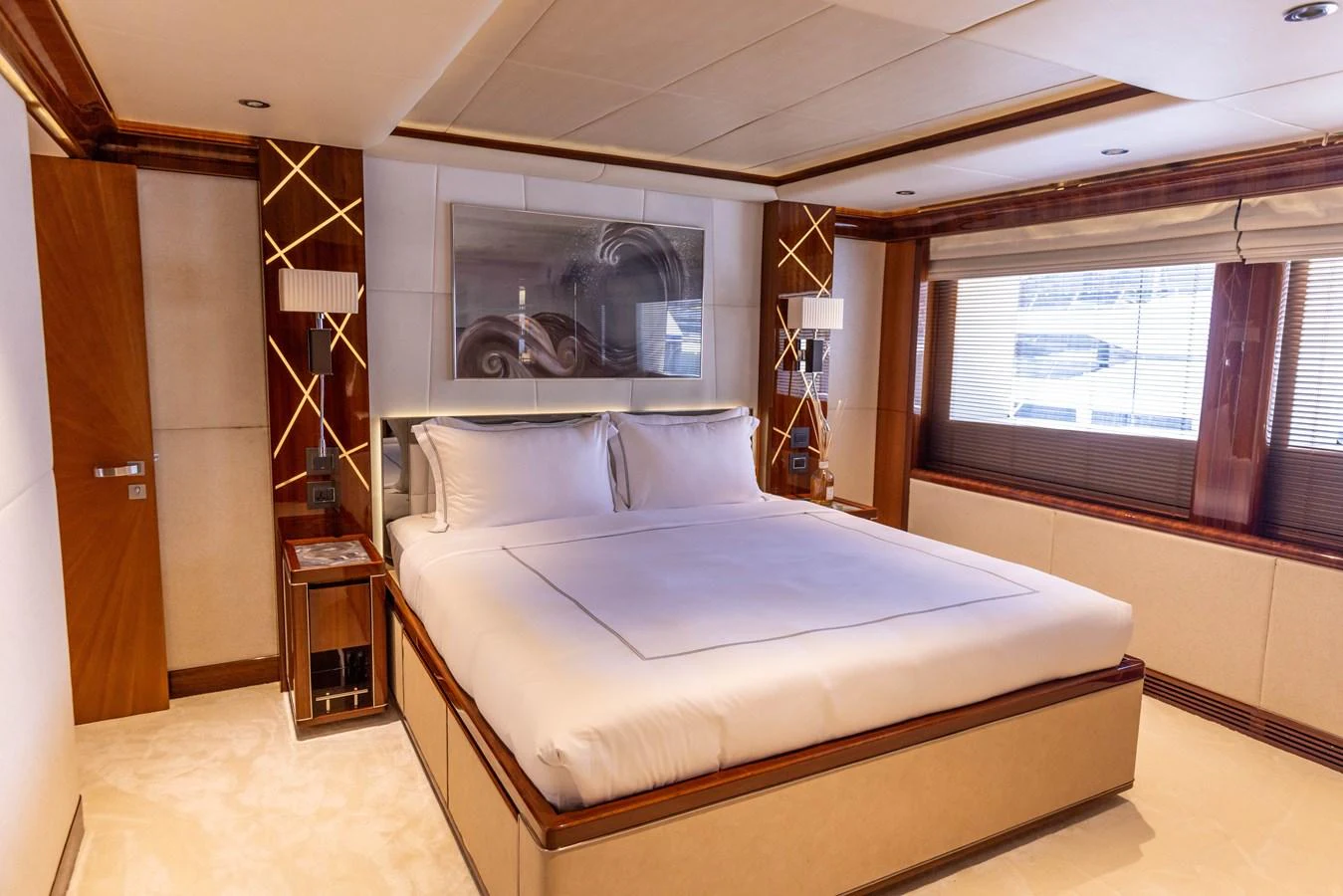 The master stateroom features a luxurious bed with elegant decor and ample natural light. aboard ATLANTIS Yacht for Sale