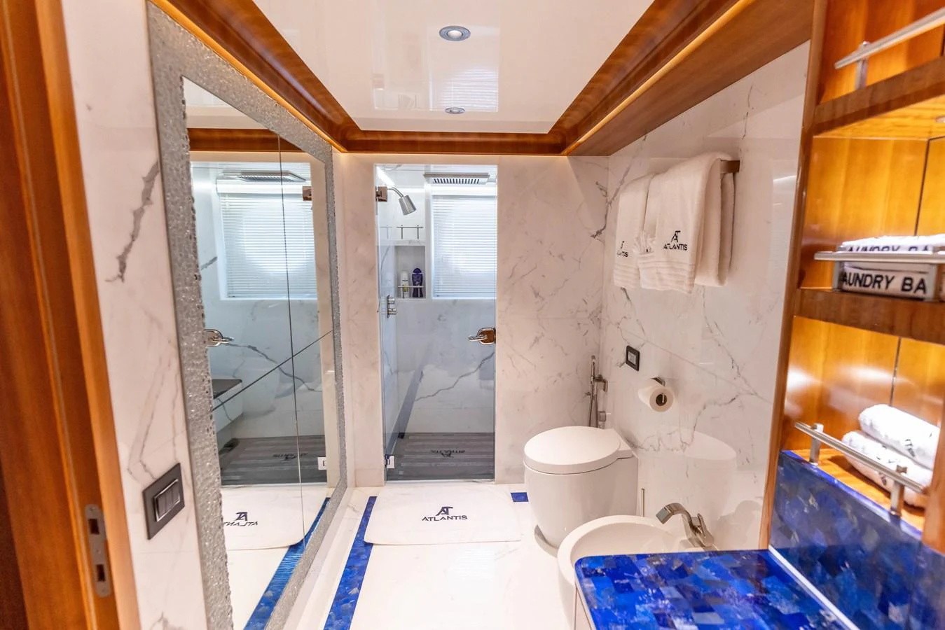 The yacht's bathroom features luxurious marble surfaces and elegant wooden accents. aboard ATLANTIS Yacht for Sale
