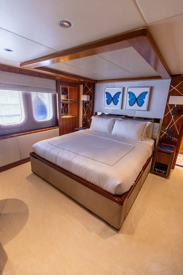 A luxurious stateroom featuring a plush bed and elegant decor. aboard ATLANTIS Yacht for Sale