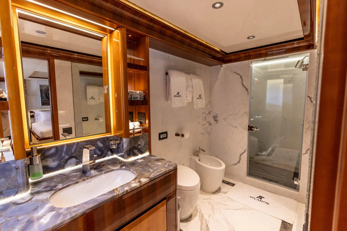 The yacht's bathroom features luxurious marble finishes and modern amenities. aboard ATLANTIS Yacht for Sale