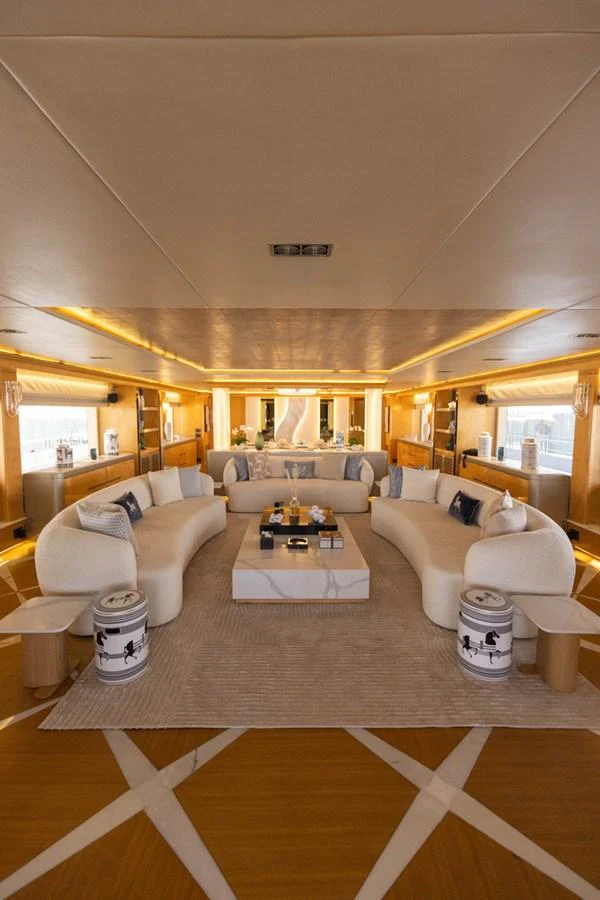 The salon features luxurious seating with elegant decor and ample natural light. aboard ATLANTIS Yacht for Sale