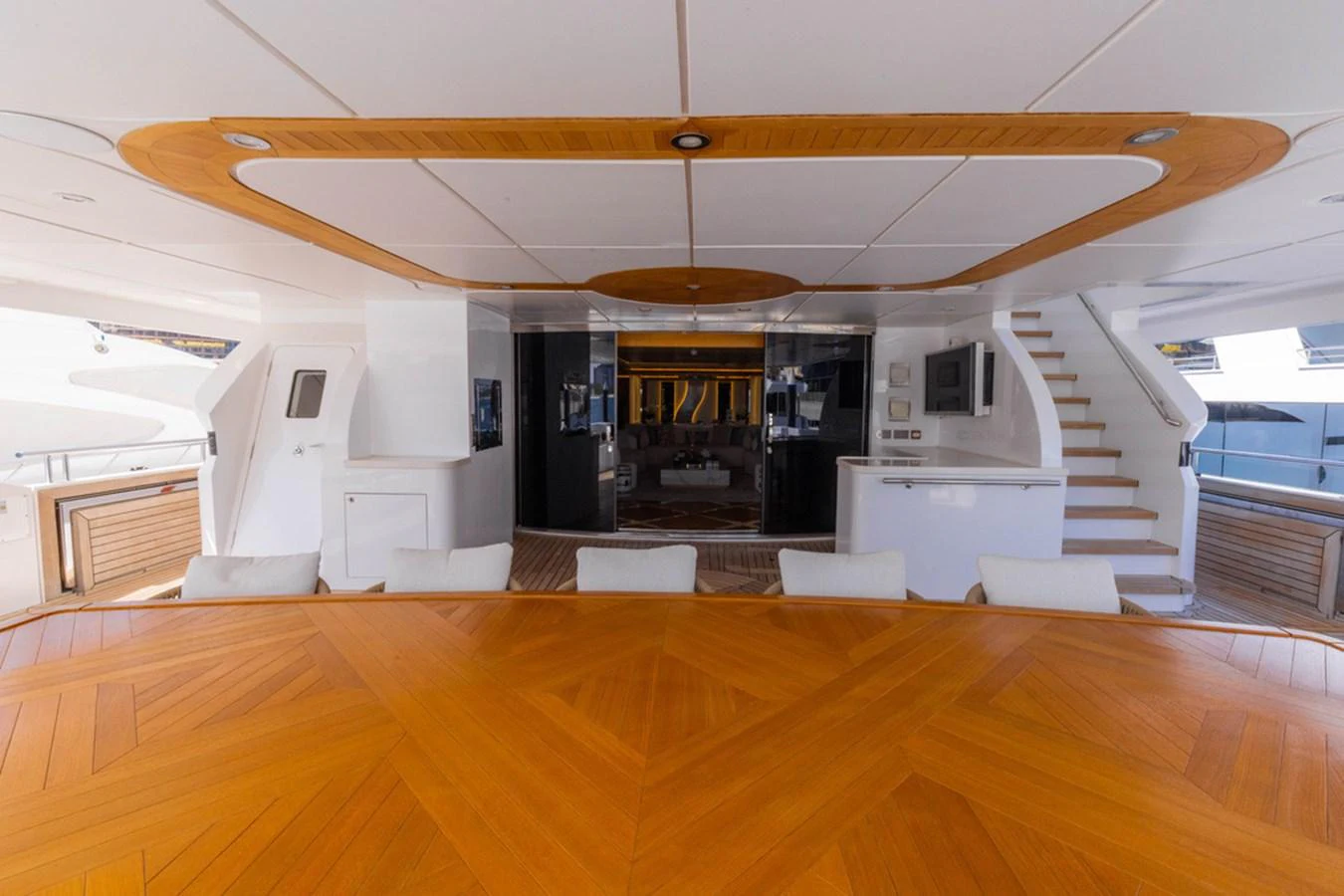 The aft deck features a spacious dining area with elegant wood finishes and comfortable seating. aboard ATLANTIS Yacht for Sale