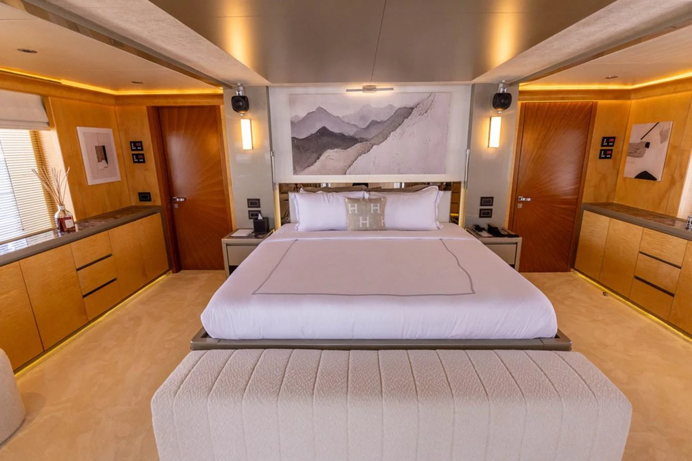 The master stateroom features a luxurious bed with modern decor and ample natural light. aboard ATLANTIS Yacht for Sale