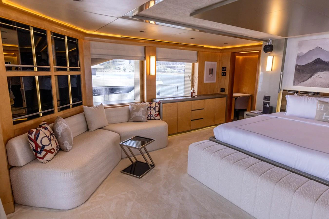 The master stateroom features a luxurious bed, comfortable seating, and large windows offering stunning views. aboard ATLANTIS Yacht for Sale