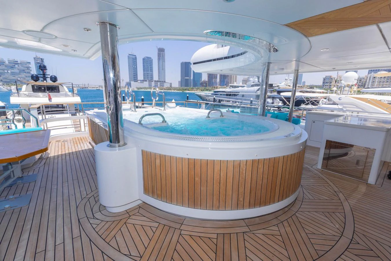 The yacht features a luxurious deck jacuzzi with a stunning view of the marina. aboard ATLANTIS Yacht for Sale