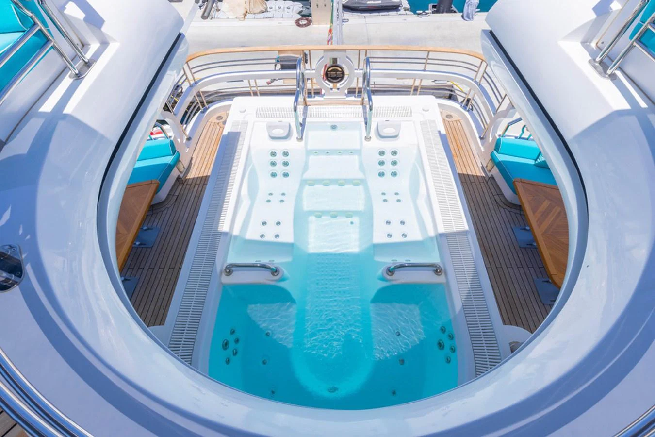 The yacht features a luxurious jacuzzi area with ample seating and elegant design. aboard ATLANTIS Yacht for Sale
