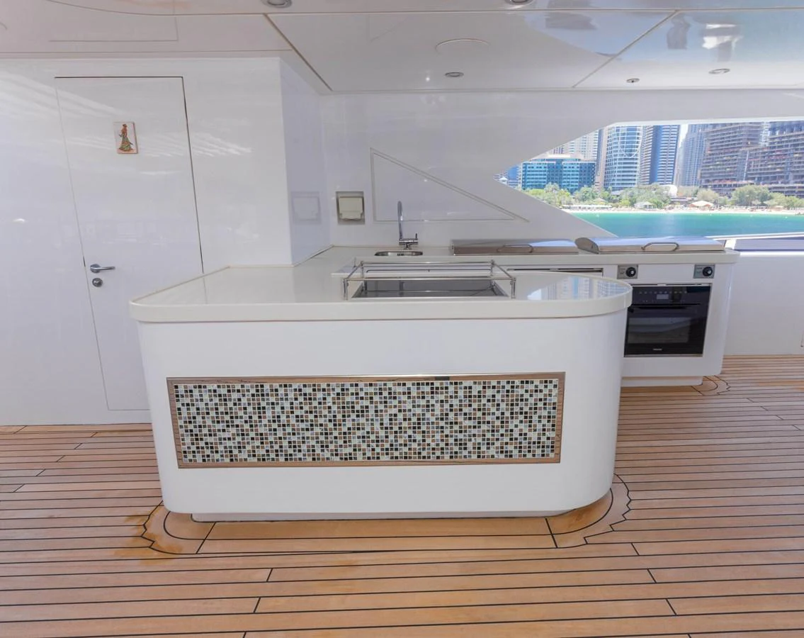 The yacht's galley features modern appliances and a sleek design with a view of the water. aboard ATLANTIS Yacht for Sale