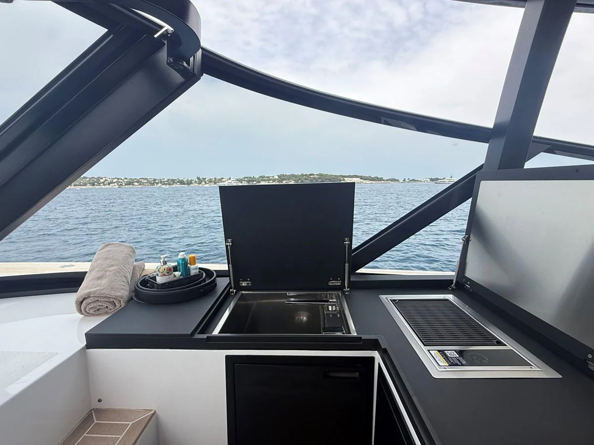 The yacht features a sleek outdoor galley with modern appliances and a stunning sea view. aboard DUTCH PEARL Yacht for Sale