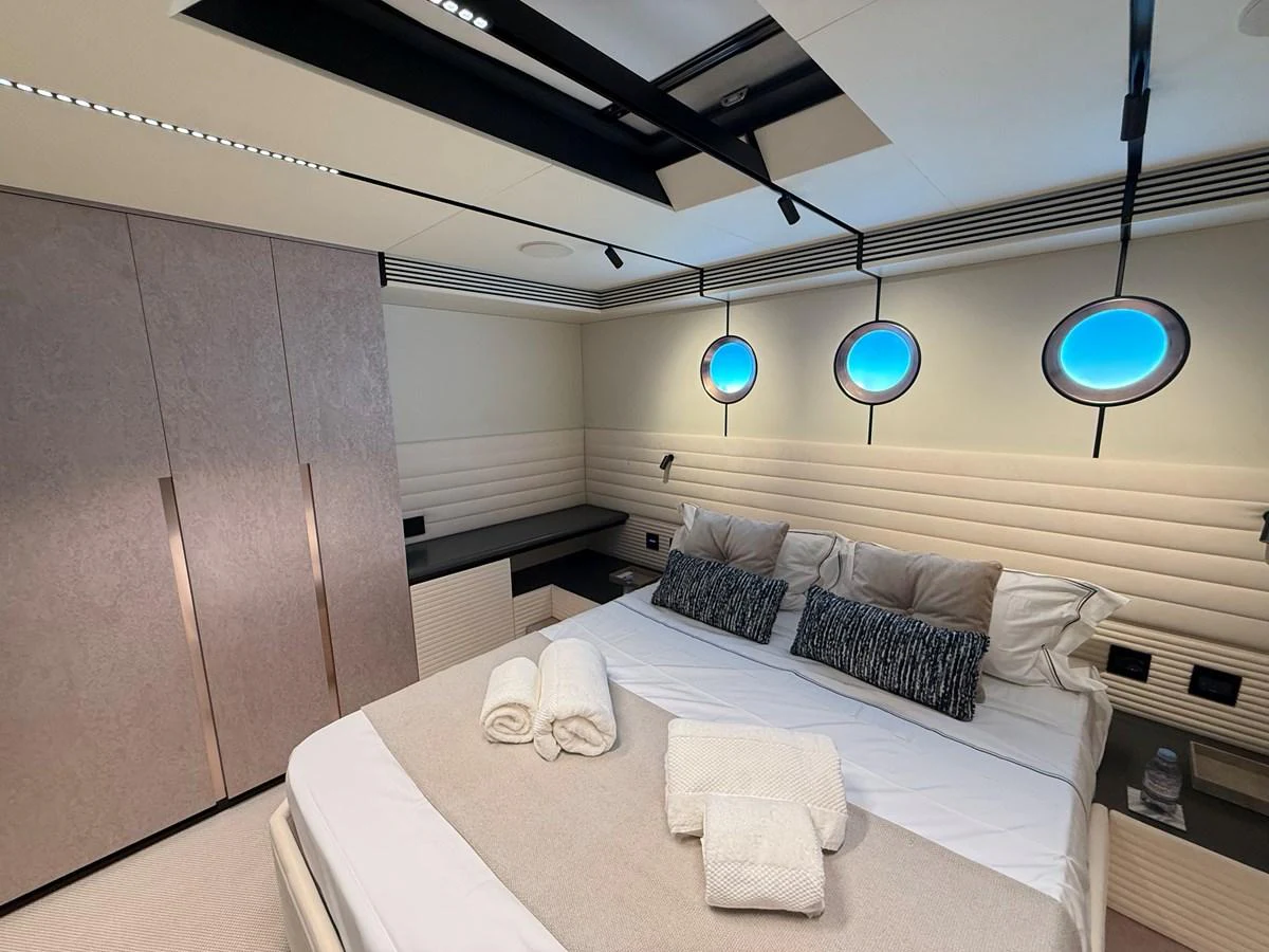 The stateroom features a comfortable bed with plush pillows and modern lighting. aboard DUTCH PEARL Yacht for Sale
