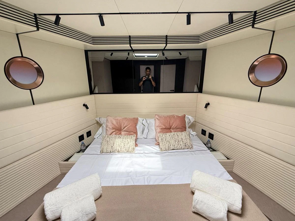 The stateroom features a cozy bed with plush pillows and modern lighting. aboard DUTCH PEARL Yacht for Sale