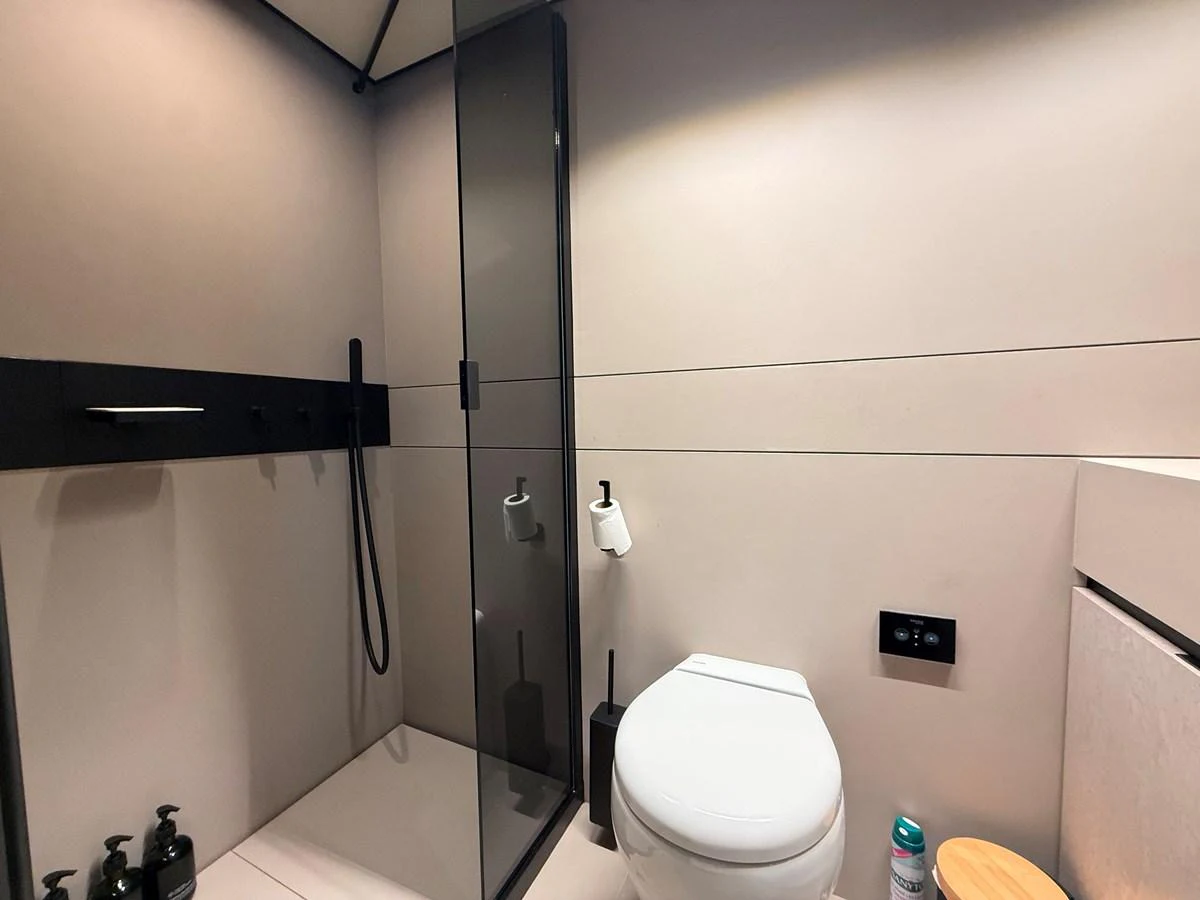 A sleek and modern yacht bathroom with a glass-enclosed shower and contemporary fixtures. aboard DUTCH PEARL Yacht for Sale