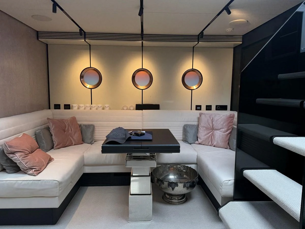The yacht's interior features a cozy seating area with plush cushions and modern lighting. aboard DUTCH PEARL Yacht for Sale