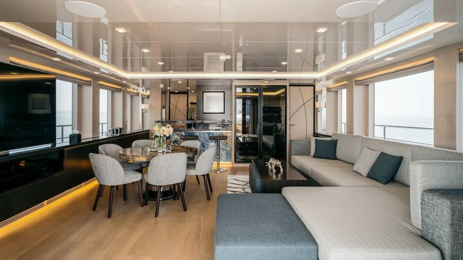 The salon offers a spacious and elegant living area with modern furnishings and ample natural light. aboard HEEUS Yacht for Sale