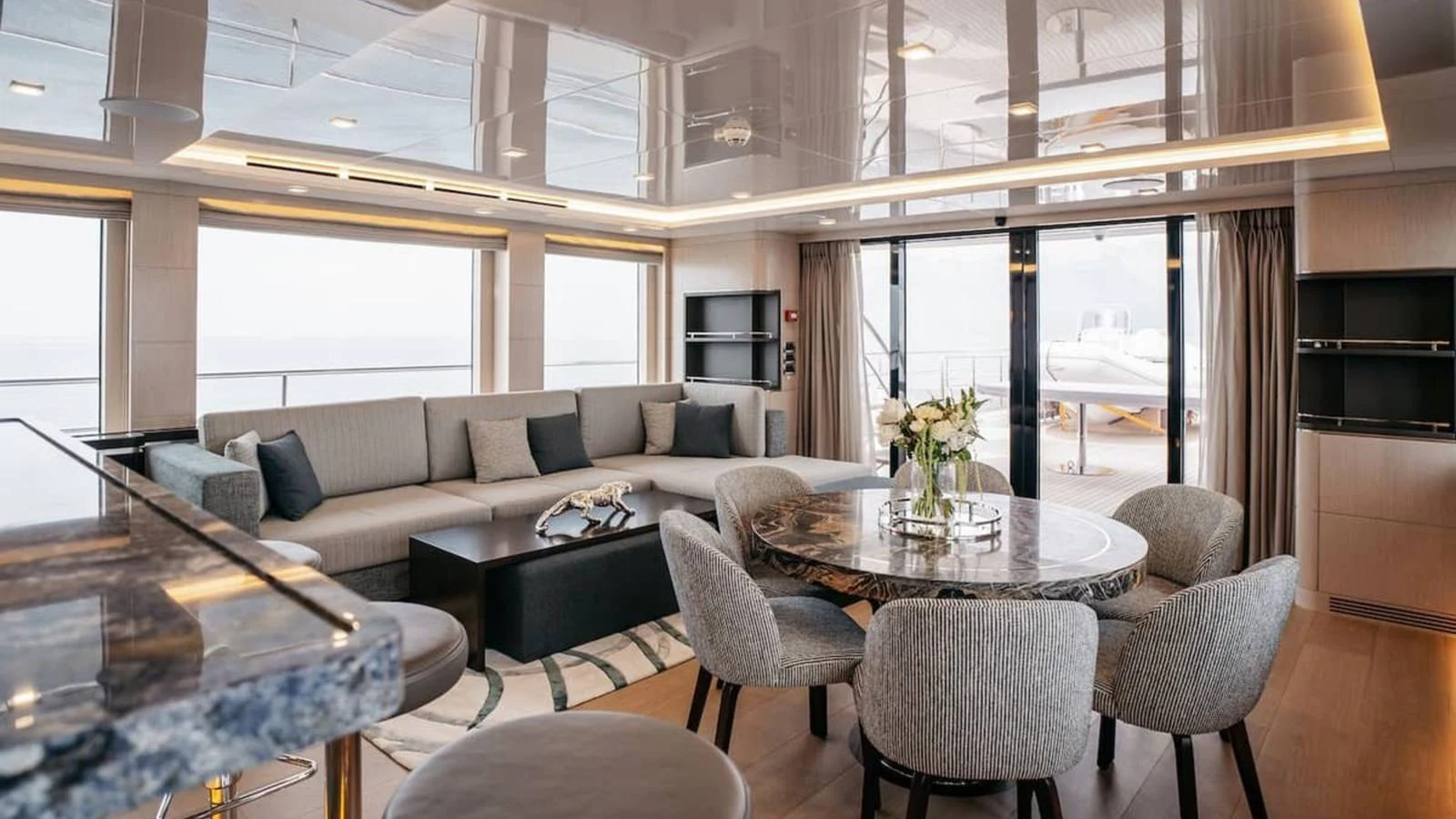 The salon features a spacious seating area with a modern design and elegant decor. aboard HEEUS Yacht for Sale