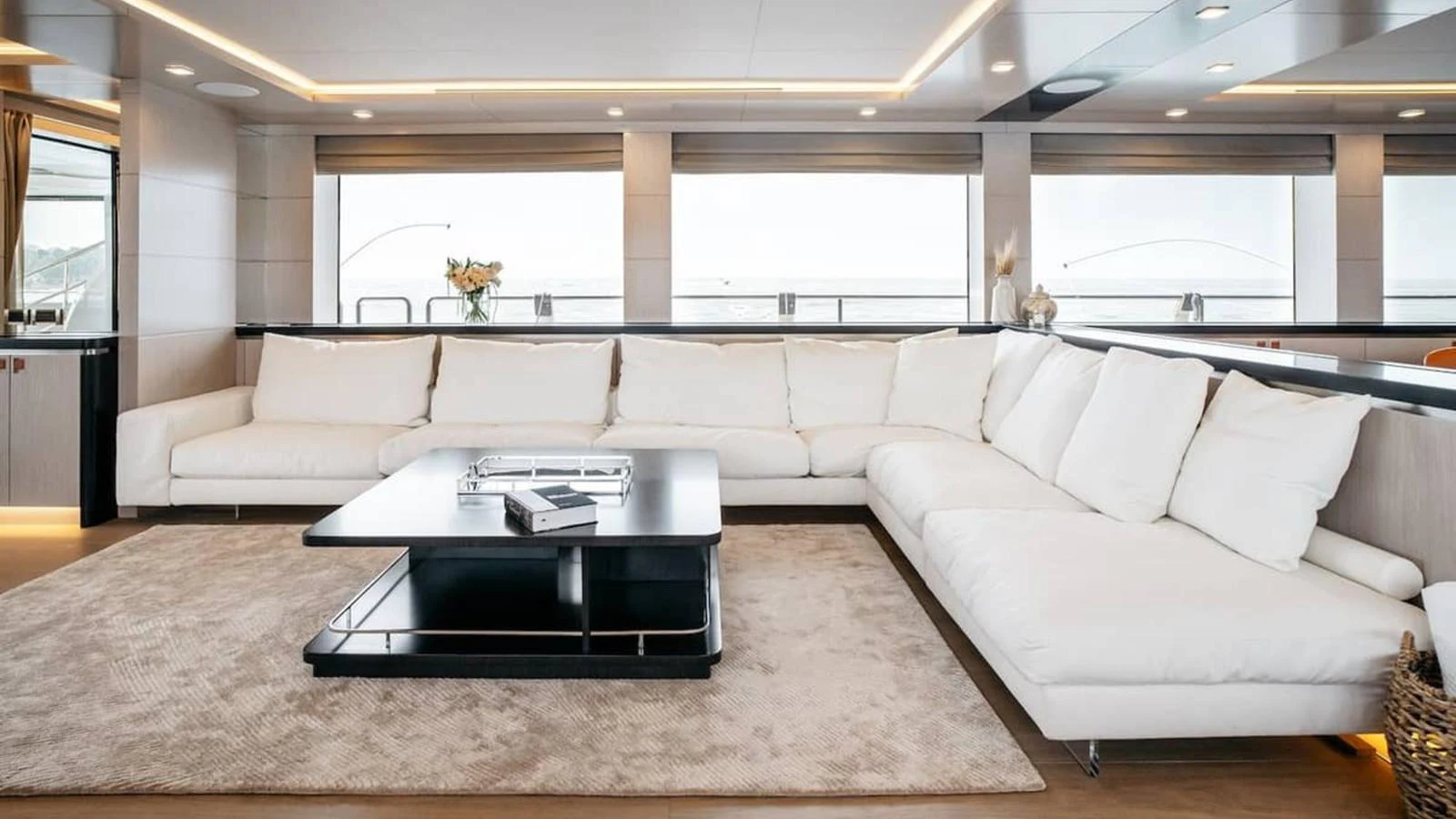The salon features a spacious and elegant seating area with large windows offering panoramic views. aboard HEEUS Yacht for Sale