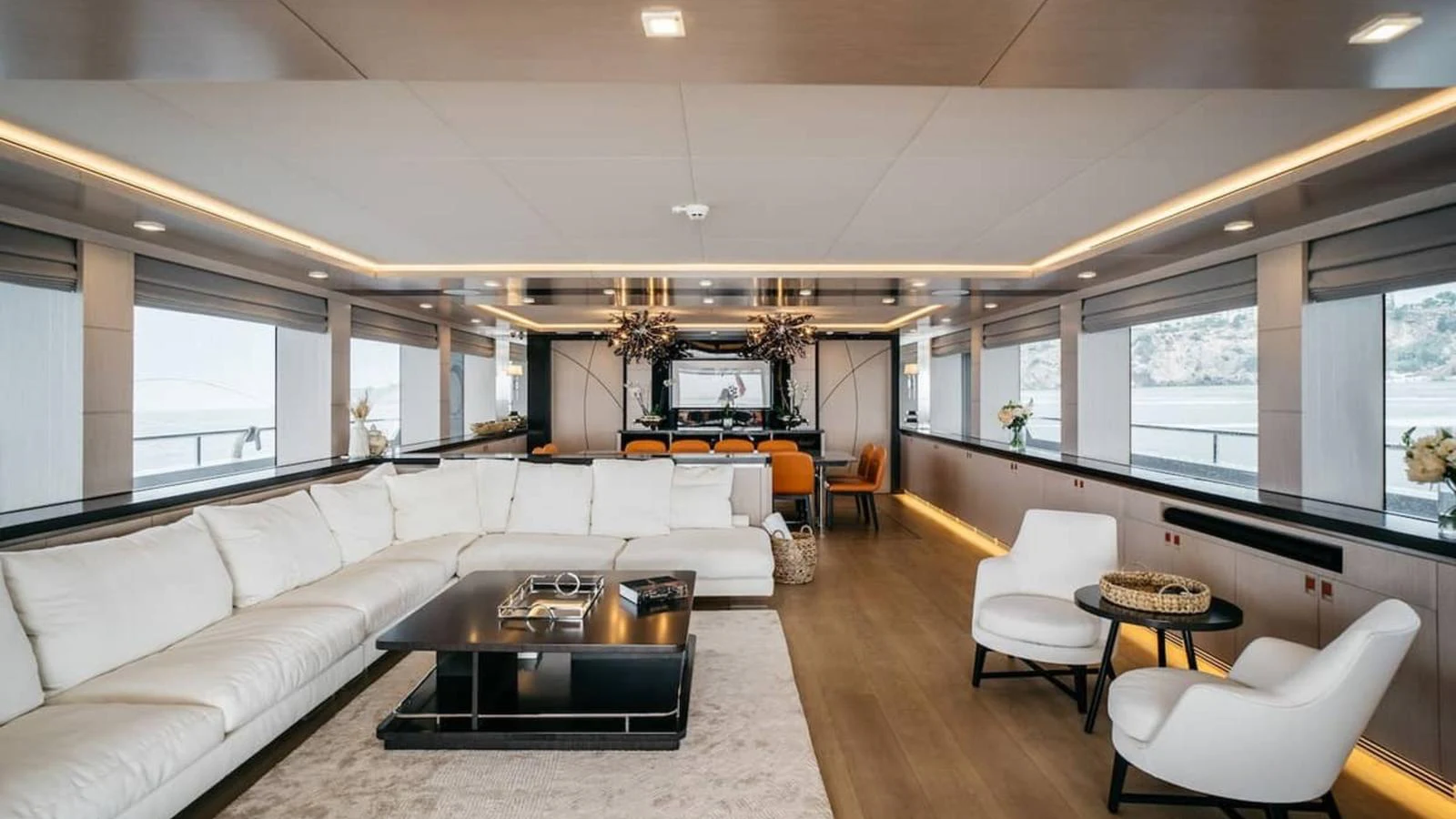 The yacht's salon features a spacious and elegantly designed seating area with panoramic windows. aboard HEEUS Yacht for Sale