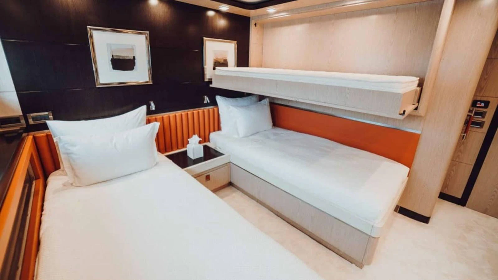 The guest cabin features twin beds with modern decor and ample lighting. aboard HEEUS Yacht for Sale