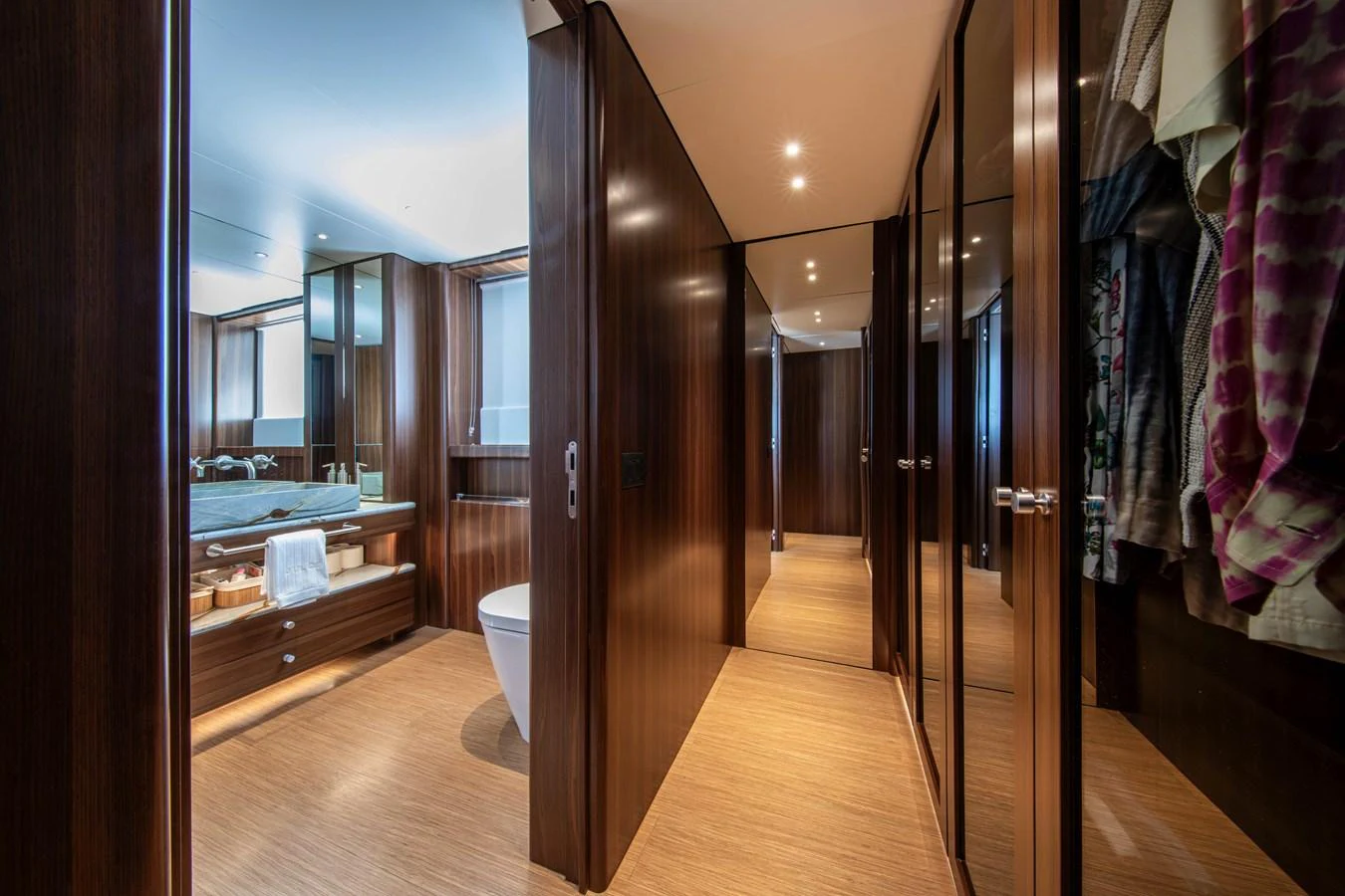 The yacht's bathroom features elegant wood paneling and modern fixtures. aboard JULES Yacht for Sale