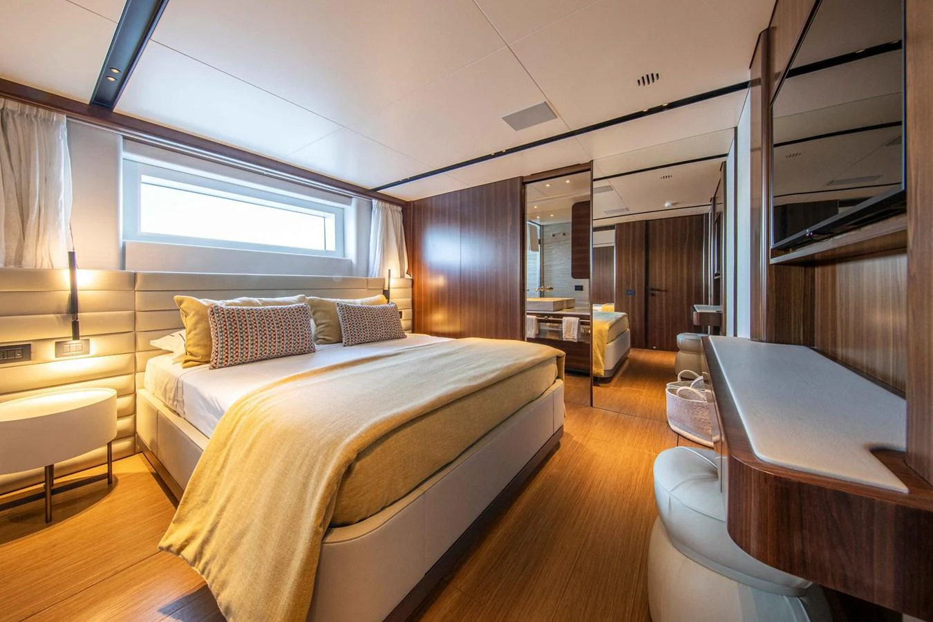 The master stateroom features a luxurious bed with elegant furnishings and ample natural light. aboard JULES Yacht for Sale