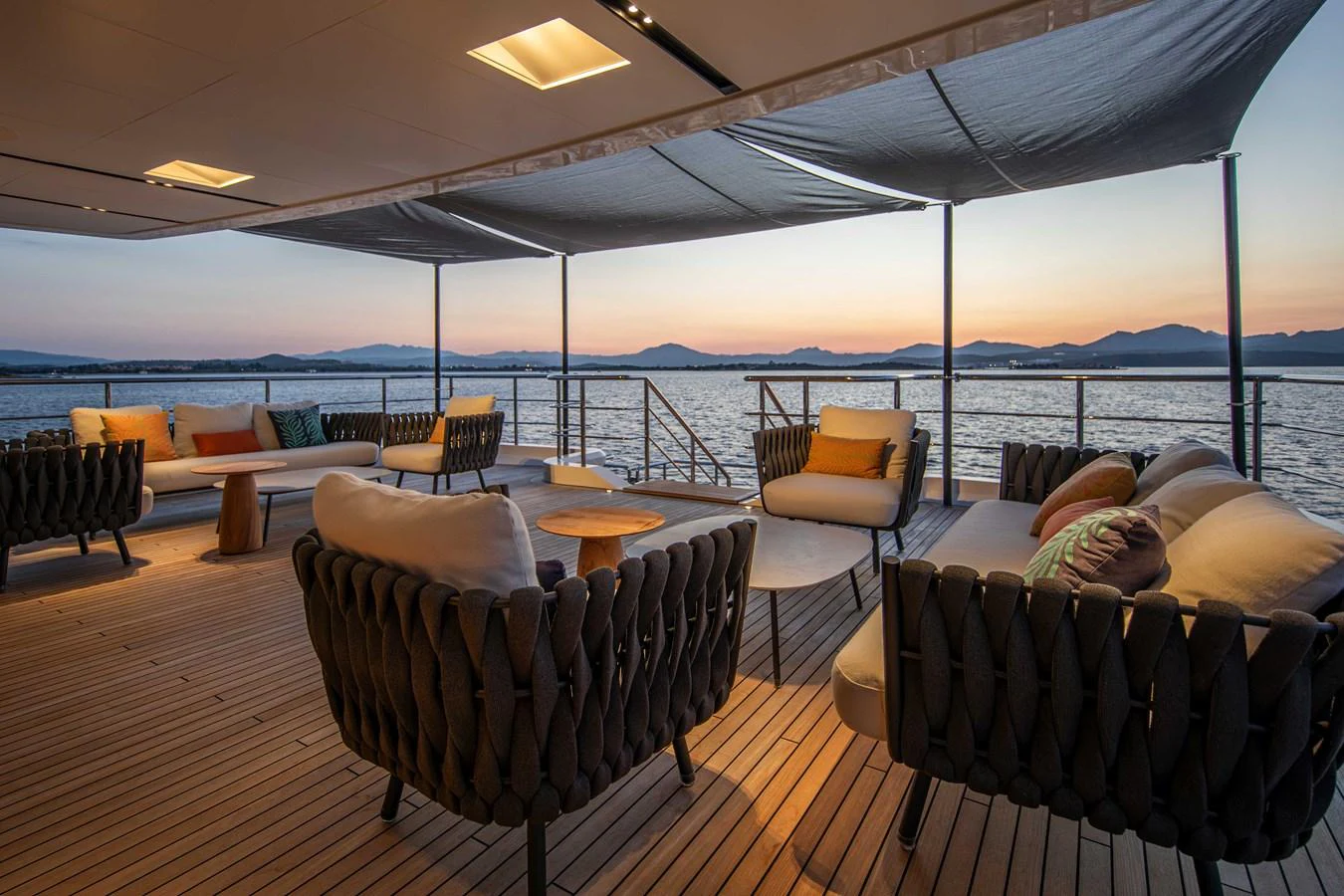 The aft deck offers a serene and stylish outdoor lounging area with comfortable seating and a stunning view of the water. aboard JULES Yacht for Sale