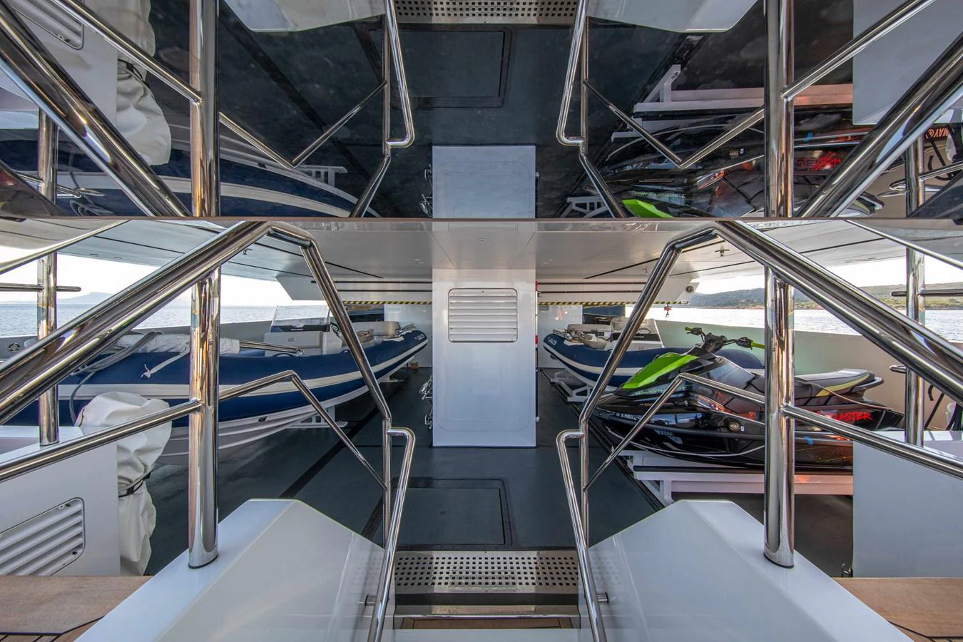 The yacht's tender garage houses multiple watercraft, including jet skis and a tender boat. aboard JULES Yacht for Sale